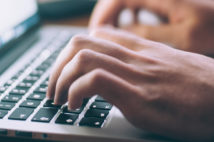 hands typing on a laptop