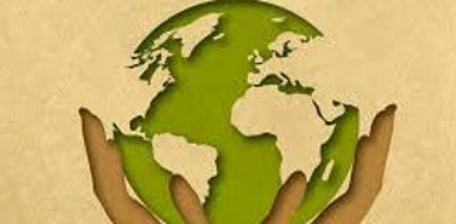 A clean Green Earth held in raised hands
